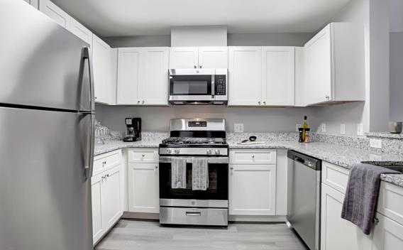Bright, airy kitchen with stainless steel appliances and updated fixtures.