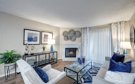 Open living room with desirable fireplace and ample seating for residents in Aurora, Colorado.