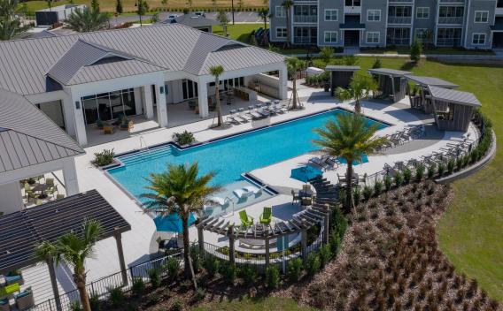 Incredible, sparkling resort style pool with luscious greenery.