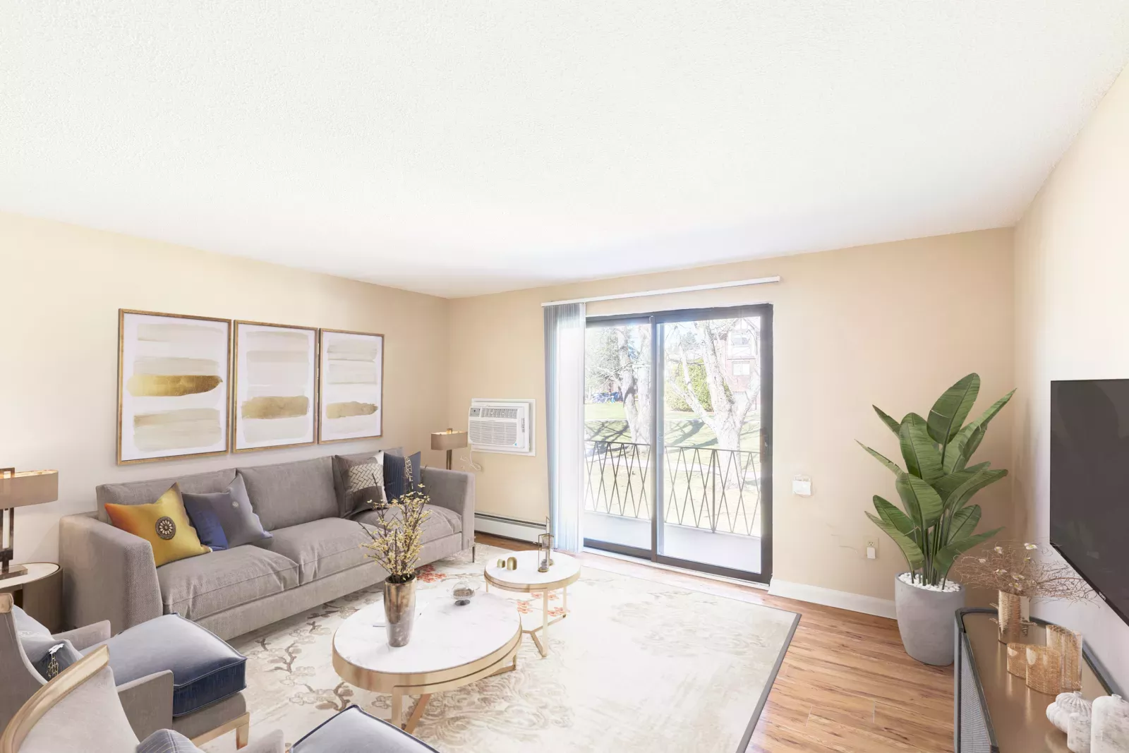 Royal Crest Estates Marlboro living room with sliding glass doors – Bright living room with contemporary furnishings, sliding glass doors, and private balcony views of landscaped grounds.