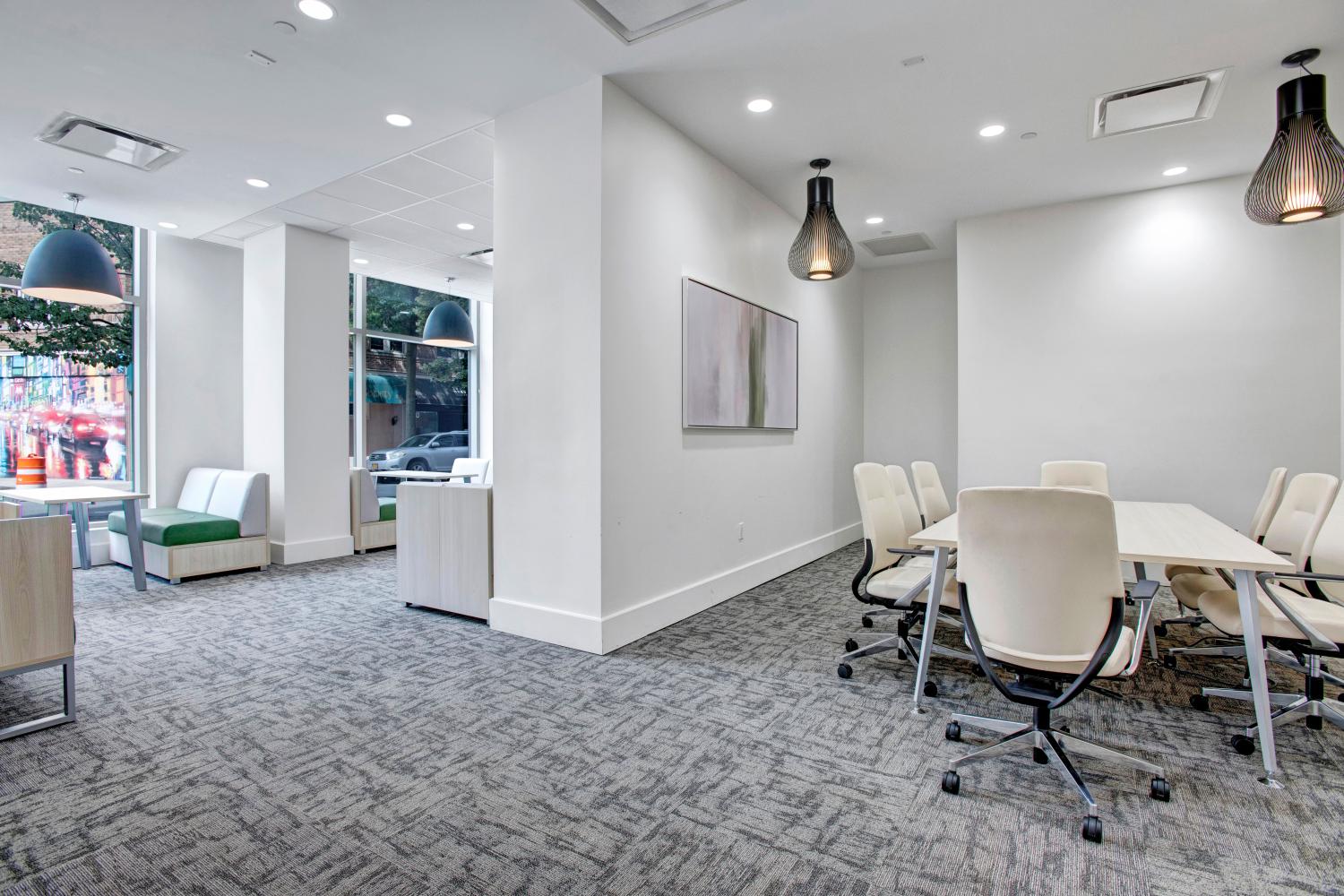 Collaborative workspace featuring cozy seating areas, natural lighting, and contemporary furniture.
