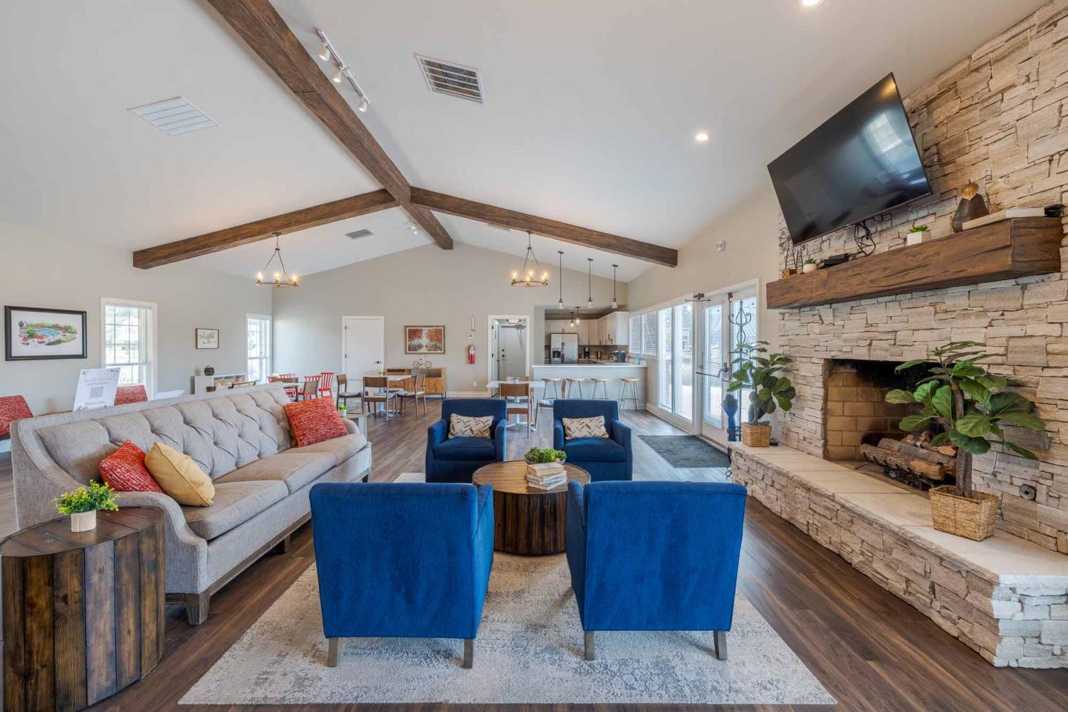 Expansive clubhouse with comfortable, ample seating and TVs for residents to enjoy.