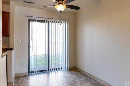 A spacious living room with plush seating and a dining area, showcasing the cozy and welcoming interiors of North River Place Apartments