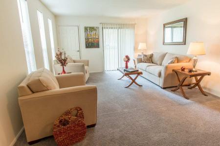 Welcoming living space with soft furnishings, warm lighting, and a tranquil atmosphere at Forest Creek Apartments