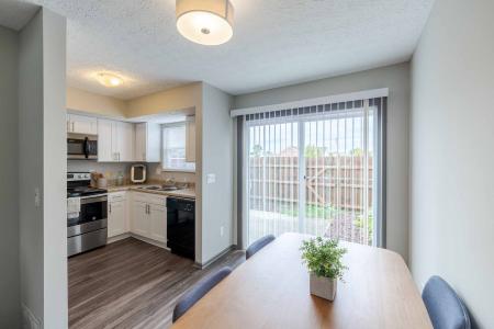 Kitchen nook connected to the kitchen area with a sliding-glass door overlooking the outdoor area.