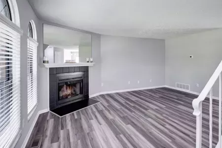 Living room with fireplace and easy access to the stairs to go to the second level.