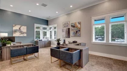 Modern leasing office with stylish furnishings, large windows providing natural light, and a welcoming atmosphere, offering a professional and comfortable space for residents and guests.