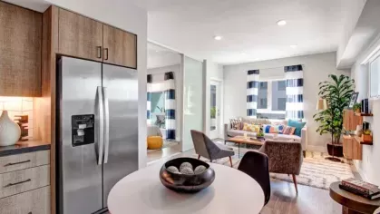 Kitchen with a dining table and stainless appliances.