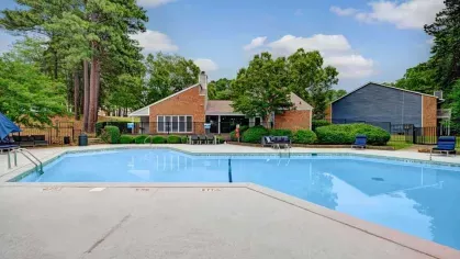 Spacious pool area with a view of the community clubhouse.