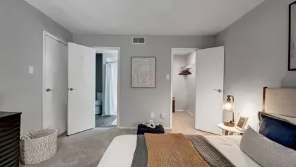 A bedroom featuring a comfortable bed and direct access to a bathroom and walk-in closet.