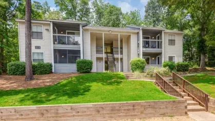 Modern apartment building exterior with spacious balconies and well-maintained landscaping.