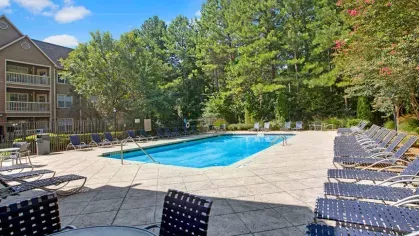 Additional pool area with surrounding greenery and shaded seating.