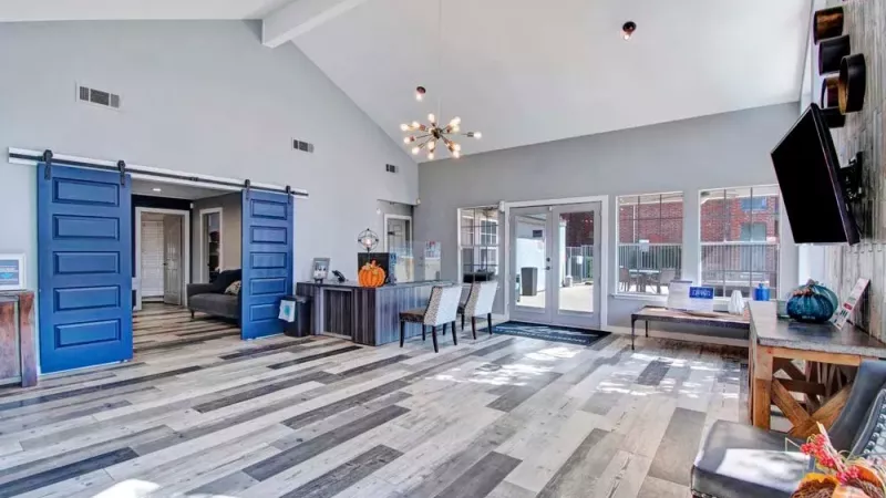 Chic community clubhouse with modern decor, sliding barn doors, and ample seating.