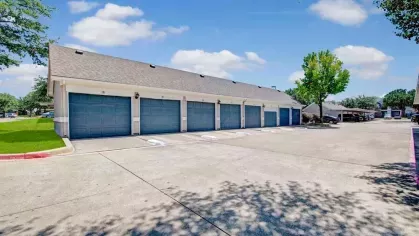 Private garages within the community, offering secure and convenient parking options for residents. The well-maintained area is surrounded by landscaped greenery and ample outdoor space.