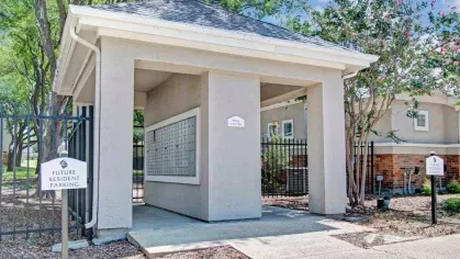 Covered mail center located within the community, featuring easy access and a clean, organized design. Surrounded by trees and well-kept landscaping, this area ensures convenience for residents.