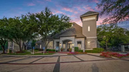 The leasing office building with a unique architectural design and beautifully landscaped surroundings.