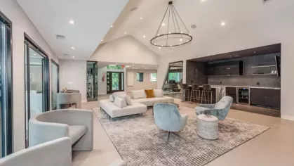 A stylish resident lounge with comfortable seating, modern lighting, and a chic bar area.