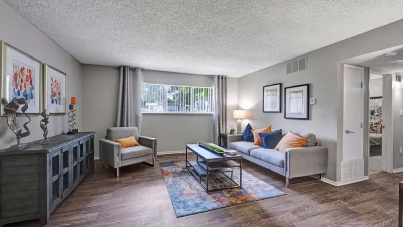 An inviting living space with a comfortable seating arrangement, colorful throw pillows, and an elegant console table.