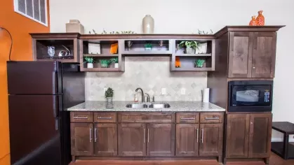 A charming leasing office surrounded by lush green trees and a welcoming entrance.