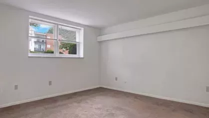Another angle of a light-filled bedroom with a view of the outdoors.