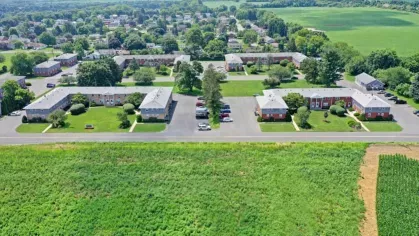 Aerial view showcasing the neat layout of residential units, courtyards, and surrounding fields.