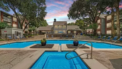 Charming outdoor patio overlooking landscaped grounds with a cozy seating arrangement.