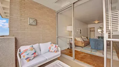 An inviting outdoor seating area connected to the living space through glass doors.