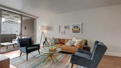 A bright and airy living space with floor-to-ceiling windows leading to a private balcony.