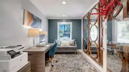 A cozy business center with a desk, a chair, and stylish decor, providing a productive workspace.