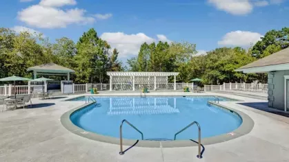 A sparkling swimming pool surrounded by gazebos and lounge seating offers a refreshing outdoor retreat.