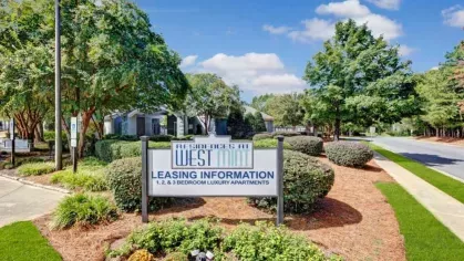 Leasing information sign for Residences at West Mint, showcasing 1, 2, and 3-bedroom luxury apartment homes.