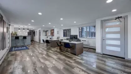 The leasing office combines modern furnishings with a welcoming open-concept layout and bar-style seating.