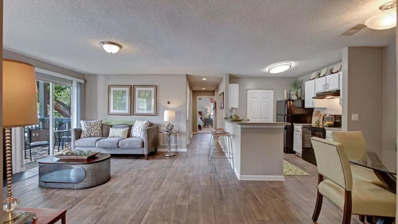 An open living space featuring sliding glass doors, a comfortable sofa, and a view of the outdoor area.