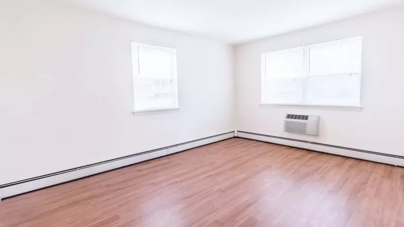 A virtually staged living and dining area with comfortable furniture, wall art, and decorative accents, showcasing the potential of the space.