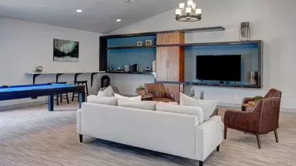 A relaxing resident lounge at 505 West Apartments with a pool table, modern decor, and a coffee bar for socializing and entertainment.