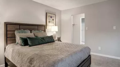 A stylish bedroom with a walk-in closet and neutral-toned walls, offering ample storage space and a comfortable living environment at 505 West Apartments