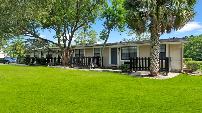 Single-story residences with individual fences and tree-lined surroundings.