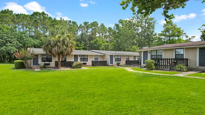 A quaint residential community with homes shaded by mature trees.