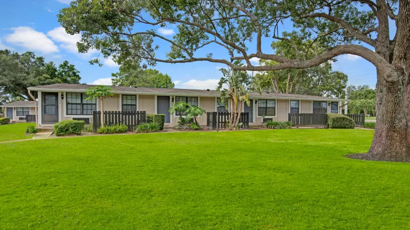 A serene residential area with trees and neatly maintained outdoor spaces.