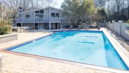 Outdoor pool and clubhouse area at Chatsworth Apartments, offering a relaxing environment and recreational amenities.