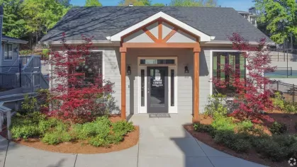 The fitness center at Chatsworth Apartments with modern architecture surrounded by vibrant landscaping.