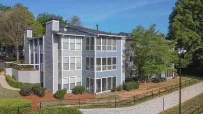 Exterior of Chatsworth Apartments in Chamblee, GA, showcasing well-maintained landscaping and contemporary apartment design.