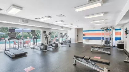 Fully equipped fitness center featuring cardio machines, free weights, and training equipment for a healthy lifestyle.