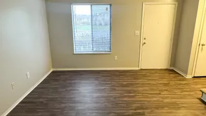 Cozy dining space with wood-style flooring, a ceiling fan, and sliding glass doors leading to a private patio or yard.