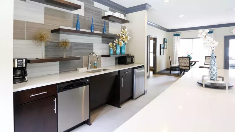 A modern business center at Norcross Crossings Apartments with a computer and printer, ideal for residents' remote work or study needs.