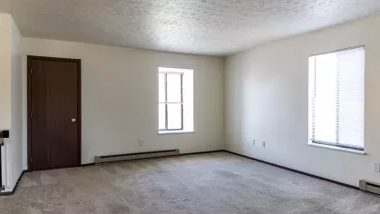 An open-concept living area with ample natural light, neutral tones, and a welcoming ambiance, ideal for comfortable living.