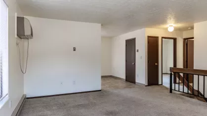 An open-concept living area with ample natural light, neutral tones, and a welcoming ambiance, ideal for comfortable living.