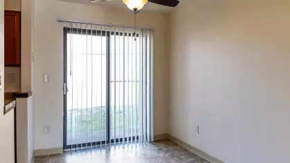 A spacious living room with plush seating and a dining area, showcasing the cozy and welcoming interiors of North River Place Apartments