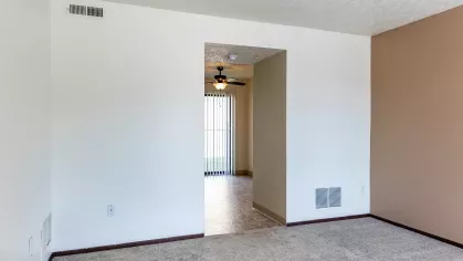 A spacious living room with plush seating and a dining area, showcasing the cozy and welcoming interiors of North River Place Apartments