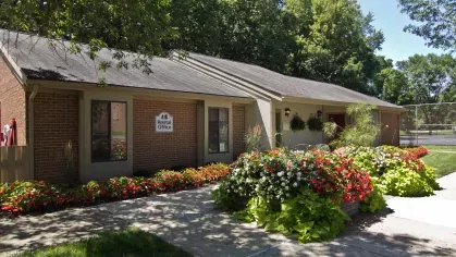 The rental office at North River Place Apartments, surrounded by vibrant flowerbeds and greenery, provides a welcoming and professional space for residents